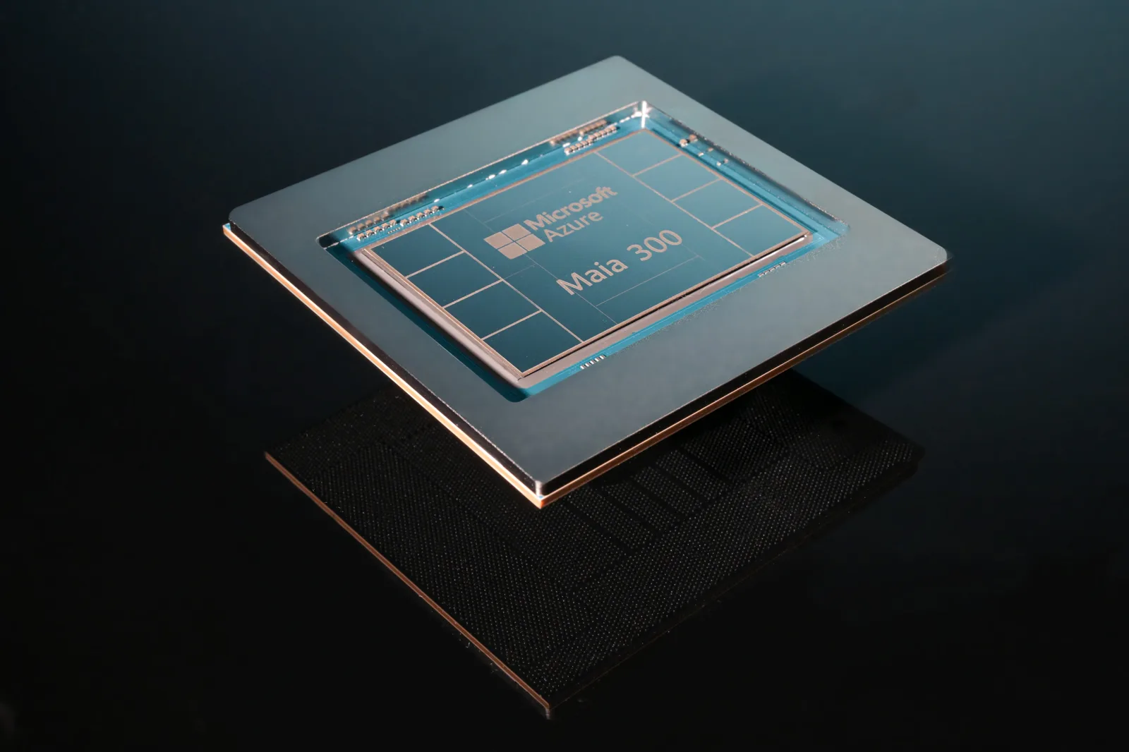A Microsoft Azure Maia 300 AI accelerator chip on a dark surface.