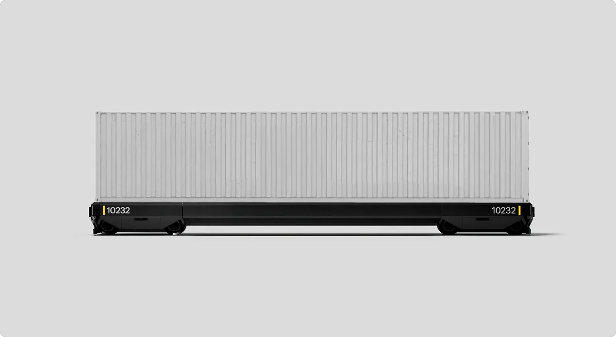 A Parallel Systems autonomous rail vehicle carrying a white shipping container.